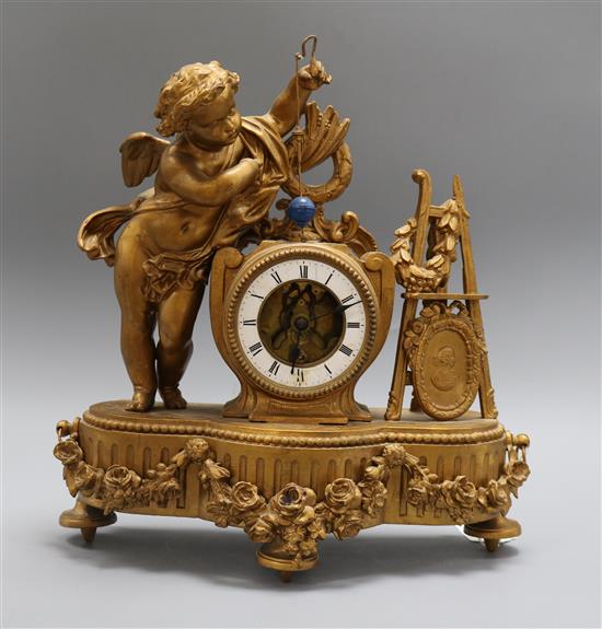 A spelter mantel clock mounted with a cherub, revolving pendulum height 37cm